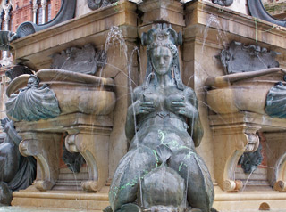 Erotic metal sculptures of mermaids on the Neptune Fountain in Bologna.