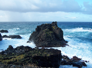 waves smashing against the rocky lava coastline